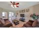 Cozy living room with tile floors, ceiling fan, comfortable seating, and seamless flow into other living areas at 2218 Valterra Vista Way, Valrico, FL 33594
