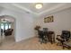 Bright home office with neutral walls, tile floors, a tray ceiling, and a workspace with computer at 2218 Valterra Vista Way, Valrico, FL 33594