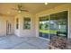 Covered patio featuring a ceiling fan and sliding glass doors to the backyard at 2218 Valterra Vista Way, Valrico, FL 33594