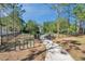 Community playground featuring a paved walkway, bike rack, and fenced play area amidst mature trees and landscaping at 2218 Valterra Vista Way, Valrico, FL 33594