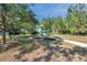 A neighborhood playground and play structure has a slide and surrounding benches for enjoying the outdoors at 2218 Valterra Vista Way, Valrico, FL 33594
