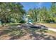 Community playground featuring a play structure, perimeter of benches for enjoying the outdoors and mature trees at 2218 Valterra Vista Way, Valrico, FL 33594
