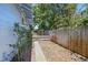 Backyard features a brick pathway, wooden fence and lush vegetation providing privacy at 2710 8Th N Ave, St Petersburg, FL 33713