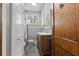 Bathroom with slate floors, wood door, modern sink, and fixtures at 2710 8Th N Ave, St Petersburg, FL 33713