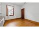 Cozy bedroom featuring hardwood floors, a window, and closet space at 2710 8Th N Ave, St Petersburg, FL 33713