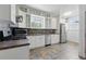 Well-lit kitchen featuring white cabinets, stainless steel appliances, and tiled backsplash at 2710 8Th N Ave, St Petersburg, FL 33713