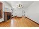 Bright living room featuring original hardwood floors, a ceiling fan, and a brick fireplace at 2710 8Th N Ave, St Petersburg, FL 33713