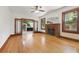 Open living room featuring original hardwood floors, a brick fireplace, and a ceiling fan at 2710 8Th N Ave, St Petersburg, FL 33713