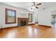 Open living room featuring original hardwood floors, a brick fireplace, and a ceiling fan at 2710 8Th N Ave, St Petersburg, FL 33713