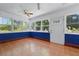 Bright and sunny sun room with a blue accent wall, neutral tiling, and multiple large windows at 2710 8Th N Ave, St Petersburg, FL 33713
