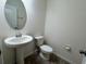 Powder bathroom features tile floors, pedestal sink, and oval mirror at 2731 Hampton Green Ln, Brandon, FL 33511