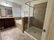 Bathroom featuring double sink vanity, bathtub, and glass shower at 2731 Hampton Green Ln, Brandon, FL 33511