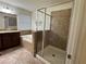 Bathroom featuring double sink vanity, bathtub, and glass shower at 2731 Hampton Green Ln, Brandon, FL 33511