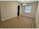 Spacious dining room with light wood flooring and modern light fixture at 2731 Hampton Green Ln, Brandon, FL 33511
