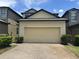 Home featuring a two-car garage and brick paver driveway at 2731 Hampton Green Ln, Brandon, FL 33511