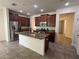 Open kitchen with stainless steel appliances, granite countertops and dark wood cabinets at 2731 Hampton Green Ln, Brandon, FL 33511