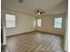 Bright living room features hardwood floors and plenty of natural light from three windows at 2731 Hampton Green Ln, Brandon, FL 33511