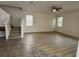 Open-concept living room boasts hardwood floors and flows seamlessly to the staircase at 2731 Hampton Green Ln, Brandon, FL 33511