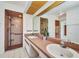 Bathroom featuring dual sinks, a shower, vanity lighting, and white tile flooring at 280 Fortaleza St, Punta Gorda, FL 33983