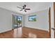 Bright bedroom with hardwood floors, ceiling fan, and sliding glass doors leading to the pool area at 280 Fortaleza St, Punta Gorda, FL 33983