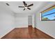 Bright bedroom features wood floors, ceiling fan, closet, and window for natural light at 280 Fortaleza St, Punta Gorda, FL 33983