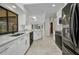 Modern kitchen featuring stainless steel appliances, quartz countertops, and tile flooring at 280 Fortaleza St, Punta Gorda, FL 33983
