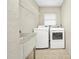 Convenient laundry room with modern appliances, storage shelf, and a utility sink at 280 Fortaleza St, Punta Gorda, FL 33983