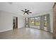Spacious living room has a ceiling fan, neutral paint, and a large window with backyard views at 280 Fortaleza St, Punta Gorda, FL 33983