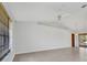 Spacious living room with tile flooring, ceiling fan, and sliding doors leading to the outdoor pool area at 280 Fortaleza St, Punta Gorda, FL 33983