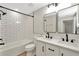 Stylish bathroom with double vanity, modern mirrors, and shower-tub combo at 28516 Tranquil Lake Cir, Wesley Chapel, FL 33543