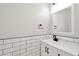 Modern bathroom with white subway tile, black fixtures, and a sleek vanity at 28516 Tranquil Lake Cir, Wesley Chapel, FL 33543