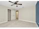 Bright bedroom boasts plush carpet, neutral walls, closet and ensuite bathroom at 28516 Tranquil Lake Cir, Wesley Chapel, FL 33543