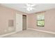 Neutral bedroom boasts plush carpet, a window, closet and a full mirror at 28516 Tranquil Lake Cir, Wesley Chapel, FL 33543