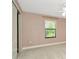 Neutral bedroom with plush carpet, a window, and a closet space at 28516 Tranquil Lake Cir, Wesley Chapel, FL 33543