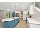 Open kitchen layout with stainless steel appliances, quartz countertops, and a center island with blue accents at 28516 Tranquil Lake Cir, Wesley Chapel, FL 33543