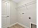 Practical laundry room with shelving and hookups at 28516 Tranquil Lake Cir, Wesley Chapel, FL 33543