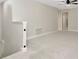 Upstairs loft area with neutral carpet and a ceiling fan at 28516 Tranquil Lake Cir, Wesley Chapel, FL 33543