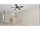 Spacious loft area with neutral carpet and ceiling fan at 28516 Tranquil Lake Cir, Wesley Chapel, FL 33543
