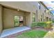 Exterior view of patio with sliding door to kitchen, and grassy area at 28516 Tranquil Lake Cir, Wesley Chapel, FL 33543
