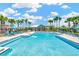 Community pool with lounge seating, umbrellas, palm trees, and a covered gazebo at 28516 Tranquil Lake Cir, Wesley Chapel, FL 33543