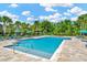 Beautiful community pool featuring lounge chairs, umbrellas, and lush landscaping, perfect for relaxation at 28516 Tranquil Lake Cir, Wesley Chapel, FL 33543