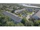 Aerial view featuring condo community near mangroves and waterfront with a serene pool area at 29 Seagrape Cir, Clearwater, FL 33759