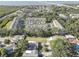 A high angle aerial shot shows the townhome community surrounded by lush trees at 29 Seagrape Cir, Clearwater, FL 33759