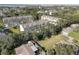 A high-angle aerial view displays the community of townhomes surrounded by green trees at 29 Seagrape Cir, Clearwater, FL 33759