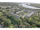 An aerial view shows a condo community with mature trees, a lake, and a swimming pool at 29 Seagrape Cir, Clearwater, FL 33759