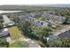 Aerial image displays a townhome community with green trees and a water view at 29 Seagrape Cir, Clearwater, FL 33759