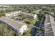 An aerial shot displays a meticulously kept condo complex boasting verdant lawns and a refreshing pool at 29 Seagrape Cir, Clearwater, FL 33759