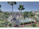 Aerial view of a community pool and well-maintained townhomes surrounded by palm trees at 29 Seagrape Cir, Clearwater, FL 33759