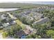 A neighborhood with many townhomes, water, and lush trees surround it as seen from an aerial view at 29 Seagrape Cir, Clearwater, FL 33759