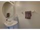 Clean powder room features a pedestal sink, decorative mirror, and neutral wall color at 29 Seagrape Cir, Clearwater, FL 33759